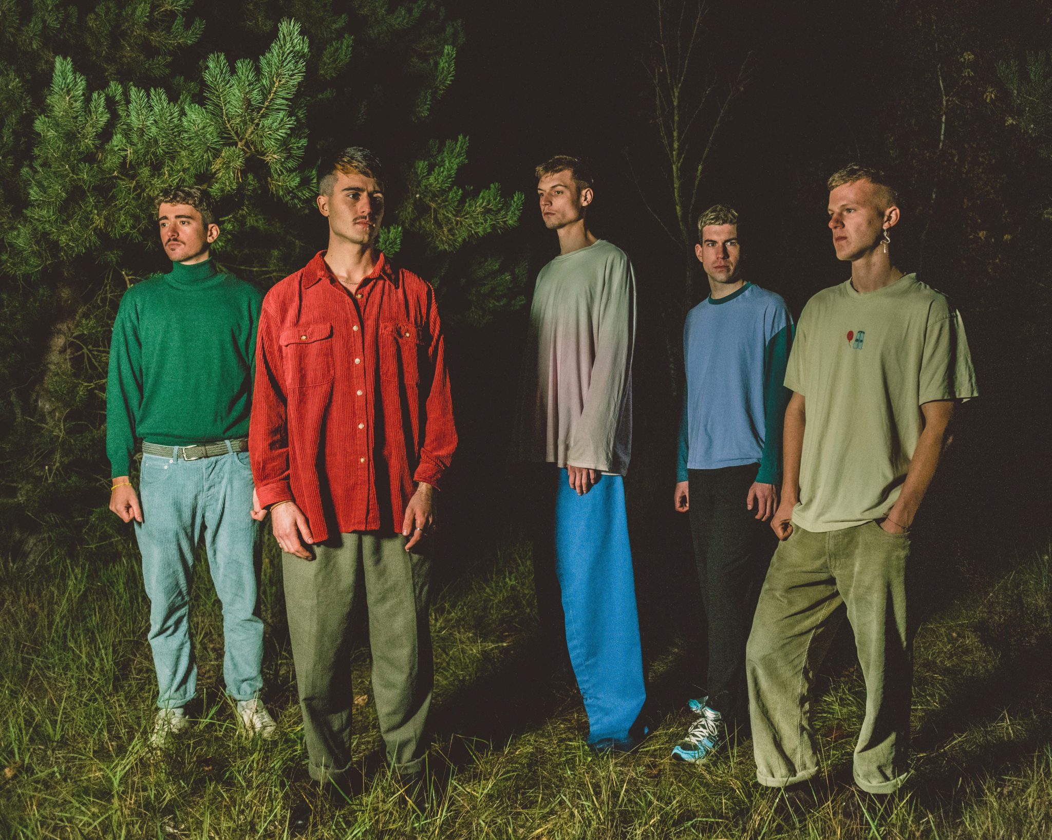 young man wearing shades and a hat with a beard, tattos and ear piercings