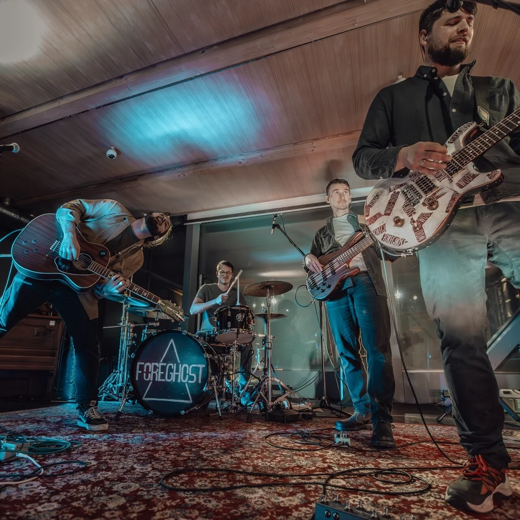 young man wearing shades and a hat with a beard, tattos and ear piercings